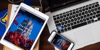 an ipad, a laptop, and an iphone on a desk