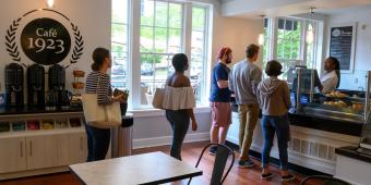 people stand in line at cafe 1923 in the william pitt union