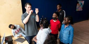 an instructor leading a class with youth at a community engagement center